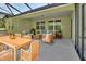 Covered patio with comfortable seating and a dining table, perfect for outdoor entertaining at 317 Nowell Loop, Deland, FL 32724