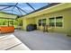 Spacious screened-in porch featuring seating, grill, and tiled flooring at 317 Nowell Loop, Deland, FL 32724