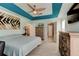 Spacious bedroom featuring a stylish tray ceiling, neutral tones, and three entry ways at 4205 Quail Ranch Rd, New Smyrna Beach, FL 32168