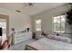 Sunlit bedroom with comfortable queen bed, workspace and white decor for a peaceful ambiance at 4205 Quail Ranch Rd, New Smyrna Beach, FL 32168