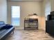 A cozy living room with a gray futon and a pet habitat next to a modern black dresser at 4205 Quail Ranch Rd, New Smyrna Beach, FL 32168