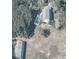 Aerial view of home with a backyard swimming pool, deck, lush greenery, and a detached outbuilding at 1440 Arroyo Vista Dr, Deland, FL 32724