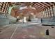 Spacious indoor barn used for recreation featuring overhead beams, lighting, and an open doorway at 1440 Arroyo Vista Dr, Deland, FL 32724