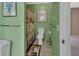 Cozy bathroom with green walls, tiled floors, and a shower with a decorative holiday themed curtain at 1440 Arroyo Vista Dr, Deland, FL 32724