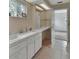 Bright bathroom featuring a double sink vanity and a doorway that leads to the bedroom at 1440 Arroyo Vista Dr, Deland, FL 32724