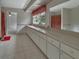 Bright bathroom featuring a long vanity with dual sinks, tiled floors, a decorative shower curtain, and large mirror at 1440 Arroyo Vista Dr, Deland, FL 32724