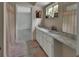 Bathroom with double sinks, tile floors, and a doorway to a bedroom at 1440 Arroyo Vista Dr, Deland, FL 32724
