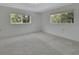 Bright bedroom with plush carpet and large windows overlooking the landscape at 1440 Arroyo Vista Dr, Deland, FL 32724