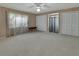 Neutral bedroom with a ceiling fan, carpeted floor, natural light and access to multiple closets at 1440 Arroyo Vista Dr, Deland, FL 32724