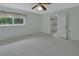 Bedroom with neutral walls, carpet, a ceiling fan, and a window providing natural light at 1440 Arroyo Vista Dr, Deland, FL 32724
