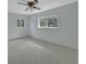 Spacious, carpeted bedroom featuring two windows with views of nature and a ceiling fan at 1440 Arroyo Vista Dr, Deland, FL 32724