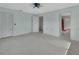 Bright and spacious bedroom with neutral carpet and walls, ceiling fan, and a closet at 1440 Arroyo Vista Dr, Deland, FL 32724