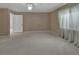 Bright bedroom featuring a carpeted floor, ceiling fan, neutral color scheme and a calming ambiance at 1440 Arroyo Vista Dr, Deland, FL 32724