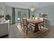 Dining area with a chandelier, large wooden table, and sliding doors to the outside at 1440 Arroyo Vista Dr, Deland, FL 32724