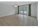 Bright dining space featuring tile flooring, a chandelier, and doors to the exterior pool at 1440 Arroyo Vista Dr, Deland, FL 32724