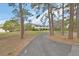 Long driveway up to a two-story home with mature trees, lush landscaping and a large front lawn at 1440 Arroyo Vista Dr, Deland, FL 32724