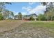 Backyard view of house with a large lawn, great for outdoor activities and enjoying nature at 1440 Arroyo Vista Dr, Deland, FL 32724