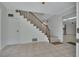 Open foyer featuring stairs with a wooden banister, tiled flooring and neutral color palette at 1440 Arroyo Vista Dr, Deland, FL 32724