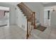 Foyer with tiled floors, carpeted staircase with wooden handrail, and two doorways leading to other rooms at 1440 Arroyo Vista Dr, Deland, FL 32724