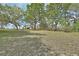 Home with large shade trees and a long driveway on a well-manicured lawn at 1440 Arroyo Vista Dr, Deland, FL 32724