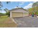 Spacious three-car garage with a wide driveway and a green lawn at 1440 Arroyo Vista Dr, Deland, FL 32724