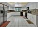 Bright kitchen with white cabinets, granite countertops, and stainless steel appliances at 1440 Arroyo Vista Dr, Deland, FL 32724