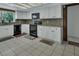 Bright kitchen with white cabinets, black appliances, and ample counter space at 1440 Arroyo Vista Dr, Deland, FL 32724