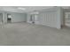 Vast living area featuring neutral carpet, mirrored wall, and ample lighting at 1440 Arroyo Vista Dr, Deland, FL 32724