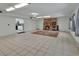 Spacious living room with tile flooring, a brick fireplace, and natural light, creating a bright and inviting atmosphere at 1440 Arroyo Vista Dr, Deland, FL 32724