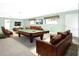Spacious living room with a pool table, comfortable sofas, and large windows at 1440 Arroyo Vista Dr, Deland, FL 32724