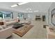 Bright living room with tile flooring, large windows with drapes, and comfortable seating at 1440 Arroyo Vista Dr, Deland, FL 32724