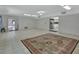 Open living room with tile floors provides plenty of space, connecting to a kitchen, perfect for a seamless flow and modern living at 1440 Arroyo Vista Dr, Deland, FL 32724