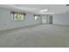 Generous living room with soft carpet, light walls and windows at 1440 Arroyo Vista Dr, Deland, FL 32724