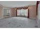 Spacious living room featuring elegant drapery, contemporary lighting, and large marble-patterned floors at 1440 Arroyo Vista Dr, Deland, FL 32724