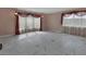 Expansive living room with marble-patterned floors, sheer drapes, and modern pendant lighting at 1440 Arroyo Vista Dr, Deland, FL 32724