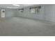 Large living room with neutral carpet, two windows, and white walls at 1440 Arroyo Vista Dr, Deland, FL 32724