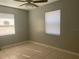 Bright bedroom features tile floors, two windows with blinds, ceiling fan, and a neutral color palette at 1110 Deltona Blvd, Deltona, FL 32725