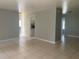 Open living room features tile flooring and light gray walls, creating a serene atmosphere at 1110 Deltona Blvd, Deltona, FL 32725