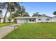 Charming ranch house with a freshly painted exterior and landscaped lawn at 1412 Ruthbern Rd, Daytona Beach, FL 32114
