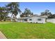 Updated ranch house with a modern exterior and well-maintained lawn at 1412 Ruthbern Rd, Daytona Beach, FL 32114