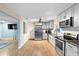 Modern kitchen with gray cabinets, stainless steel appliances, and granite counters at 1412 Ruthbern Rd, Daytona Beach, FL 32114