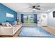 Bright living room featuring wood-look tile floors and comfy seating at 1412 Ruthbern Rd, Daytona Beach, FL 32114