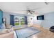 Bright living room featuring wood-look tile floors and comfy seating at 1412 Ruthbern Rd, Daytona Beach, FL 32114