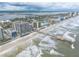 Aerial view of beachfront property with ocean, pier, and high-rise buildings at 3703 S Atlantic Ave # 501, Daytona Beach Shores, FL 32118