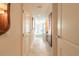 Long hallway leading to bathroom featuring a large tub and shower at 3703 S Atlantic Ave # 501, Daytona Beach Shores, FL 32118