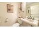 Powder room features a pedestal sink, decorative mirror, and neutral decor at 3703 S Atlantic Ave # 501, Daytona Beach Shores, FL 32118