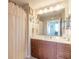 Well-lit bathroom with a spacious vanity, framed mirror, and bathtub with a shower curtain at 3703 S Atlantic Ave # 501, Daytona Beach Shores, FL 32118