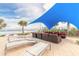 Relaxing beachfront lounge area with shade sail, comfortable seating, and ocean views at 3703 S Atlantic Ave # 501, Daytona Beach Shores, FL 32118