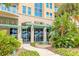 Beautiful entrance to Ocean Villas building with lush landscaping and inviting fountain at 3703 S Atlantic Ave # 501, Daytona Beach Shores, FL 32118
