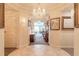 Elegant entryway with chandelier and view into living room at 3703 S Atlantic Ave # 501, Daytona Beach Shores, FL 32118
